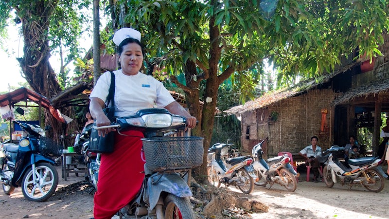A senior midwife attends to her malaria patients by motorbike in Thanintharyi region, Myanmar. Photo: James Howlett, 3DFund.org, DFAT