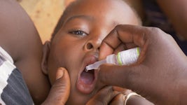 A child in Malawi gets drops to prevent polio. Photo: UNICEF