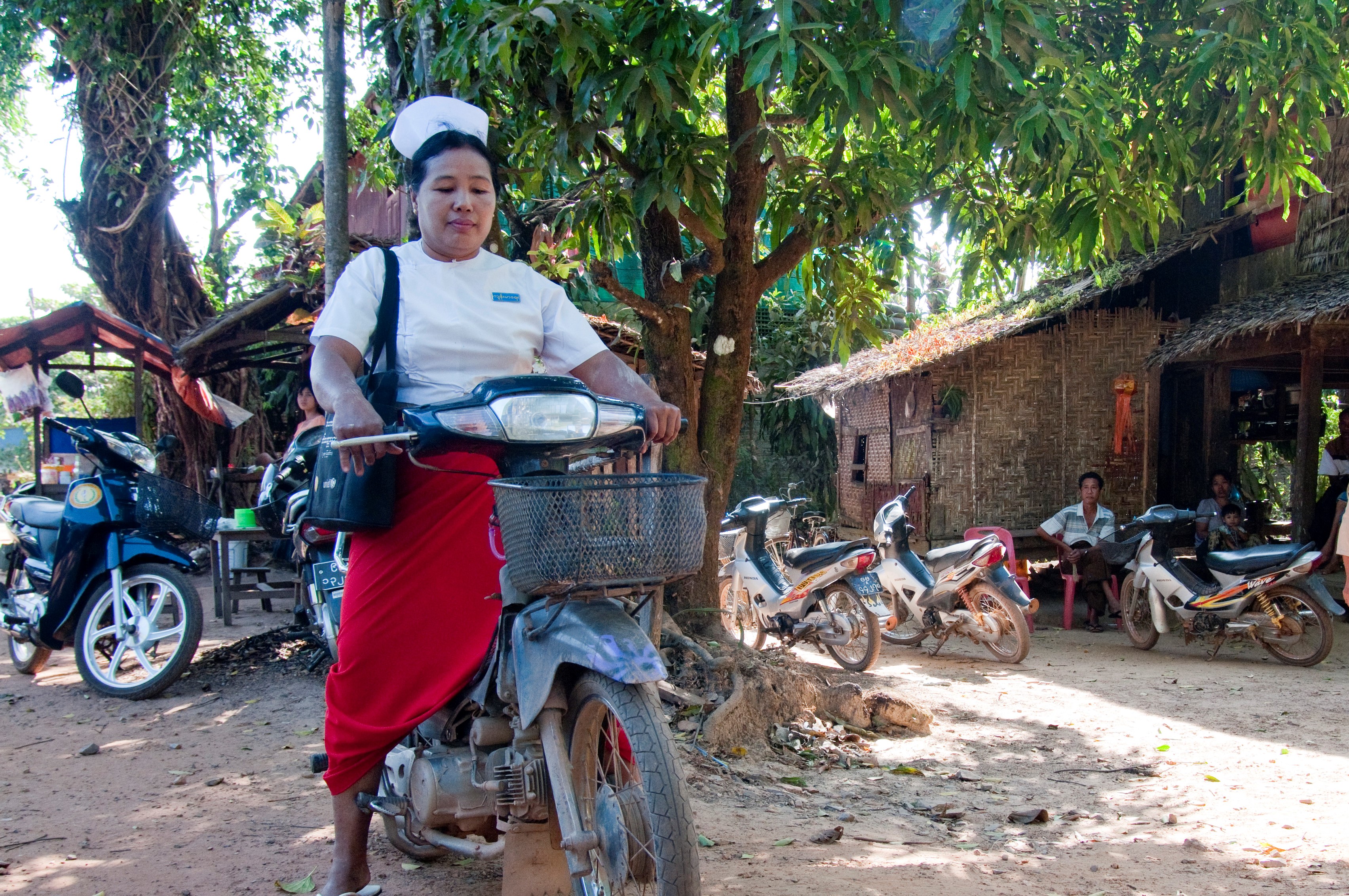 A senior midwife attends to her malaria patients by motorbike in Thanintharyi region, Myanmar. Photo: James Howlett, 3DFund.org, DFAT