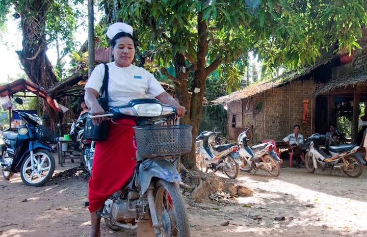 A senior midwife attends to her malaria patients by motorbike in Thanintharyi region, Myanmar. Photo: James Howlett, 3DFund.org, DFAT