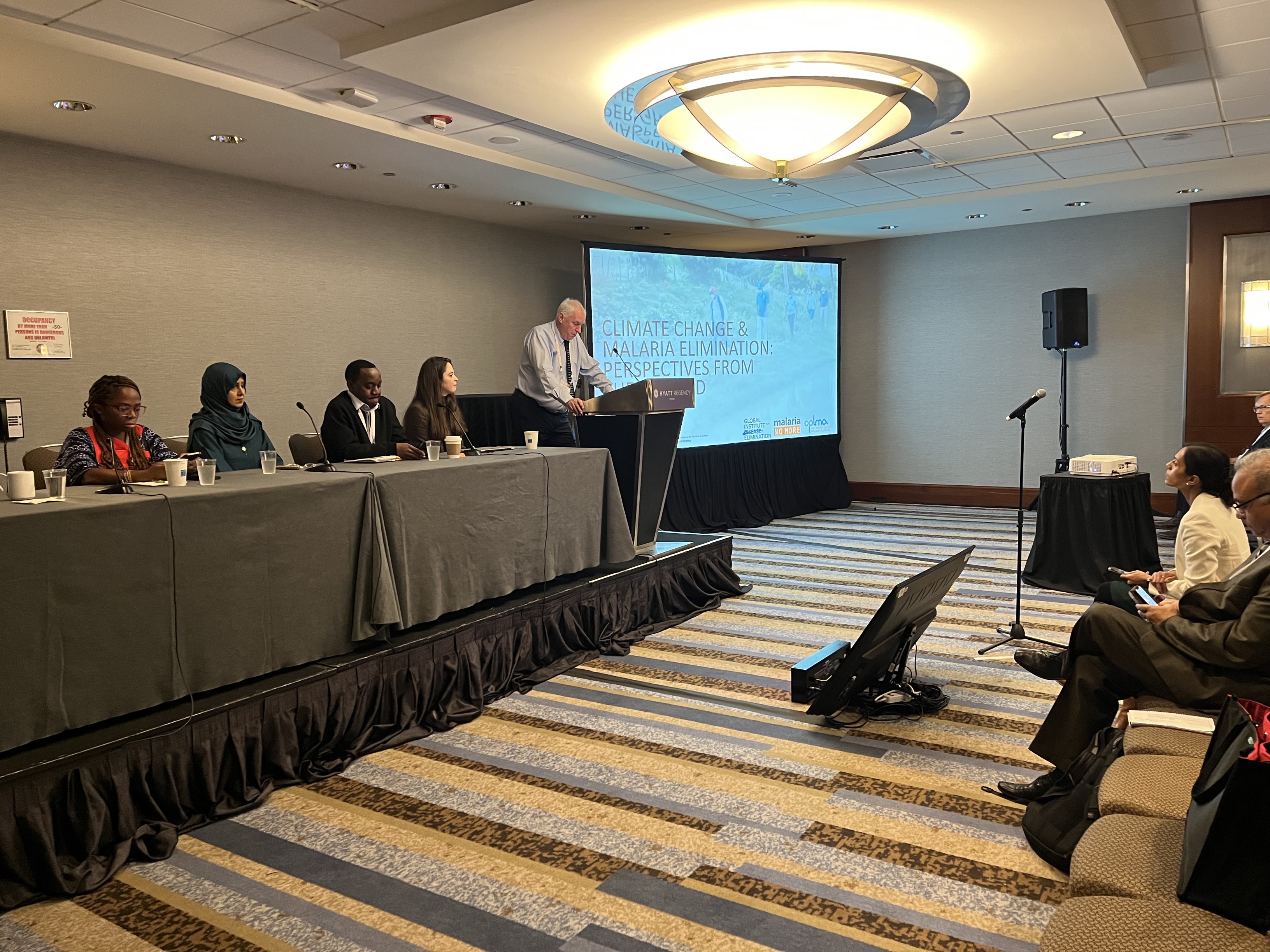 Photo of the five-speaker panel at the ASTMH symposium