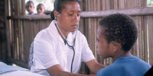 Nursing officer Janet Peters checking 8 year old Lantion Puime Health Clinic Siremi Community School Oro Province, Papua New Guniea © Don Brice ABM 2003
