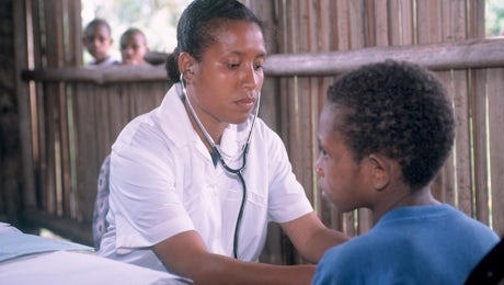 Nursing officer Janet Peters checking 8 year old Lantion Puime Health Clinic Siremi Community School Oro Province, Papua New Guniea © Don Brice ABM 2003