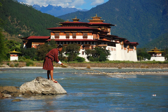 Local man cleaning the river in Bhutan. UN Photo/Gill Fickling